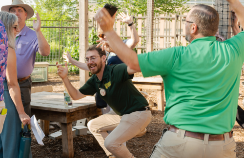 Tony dancing with educators with a large smile on his face