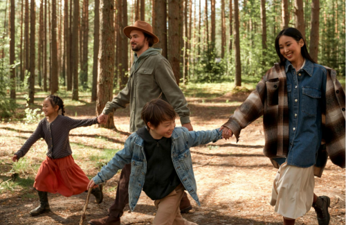 A family of four taking a gratitude walk in the forest